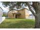 Beautiful backyard with a well-manicured lawn, white picket fence, and covered patio at 2934 Wild Tamarind Blvd, Orlando, FL 32828