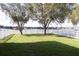 Spacious backyard featuring well-maintained lawn, mature trees, and a white picket fence at 2934 Wild Tamarind Blvd, Orlando, FL 32828