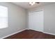 Bright bedroom features hardwood floors, neutral walls, and a large double door closet at 2934 Wild Tamarind Blvd, Orlando, FL 32828