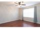 Bedroom with wood-look floors and neutral paint with one window featuring curtains at 2934 Wild Tamarind Blvd, Orlando, FL 32828