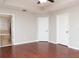 This primary bedroom is complemented by warm wood floors, neutral walls, and ensuite bathroom access at 2934 Wild Tamarind Blvd, Orlando, FL 32828