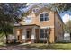 Charming two-story home featuring a well-manicured lawn and inviting front porch with stone and pillar accents at 2934 Wild Tamarind Blvd, Orlando, FL 32828