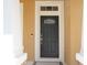 Elegant front door with decorative glass detail, framed by white trim and complemented by a stylish doorbell at 2934 Wild Tamarind Blvd, Orlando, FL 32828