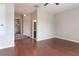 Hallway featuring warm wood floors, neutral paint and easy access to a nearby bath at 2934 Wild Tamarind Blvd, Orlando, FL 32828