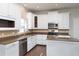 Beautiful kitchen with stainless appliances, granite countertops, white cabinetry and an island at 2934 Wild Tamarind Blvd, Orlando, FL 32828