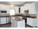 Modern kitchen featuring stainless steel appliances, white cabinets, and stone countertops at 2934 Wild Tamarind Blvd, Orlando, FL 32828