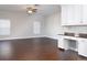 Bright living room with wood-look floors, built in desk, and large windows offering plenty of natural light at 2934 Wild Tamarind Blvd, Orlando, FL 32828