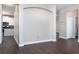 Open-concept living area showcasing wood-look floors, neutral walls, and an arched architectural detail at 2934 Wild Tamarind Blvd, Orlando, FL 32828