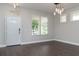 Bright living area with hardwood floors, modern light fixtures, and multiple windows providing natural light at 2934 Wild Tamarind Blvd, Orlando, FL 32828