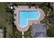 Aerial view of a community pool featuring plenty of lounge chairs, manicured landscaping, and clubhouse at 2934 Wild Tamarind Blvd, Orlando, FL 32828