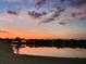 Scenic sunset view reflecting on the lake behind the homes creates a tranquil and picturesque setting at 2934 Wild Tamarind Blvd, Orlando, FL 32828
