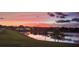 Picturesque sunset over the lake with the community homes reflecting in the water create a serene and idyllic setting at 2934 Wild Tamarind Blvd, Orlando, FL 32828