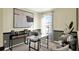 Well-lit home office with comfortable seating, a desk area, and stylish wall decor at 2976 Waterlily Way, Poinciana, FL 34759