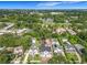 An aerial view of the neighborhood shows the lush green trees, manicured lawns, and community features at 3206 Harrison Ave, Orlando, FL 32804
