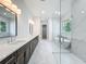 Modern bathroom with a double sink vanity, glass shower, and free standing tub at 3206 Harrison Ave, Orlando, FL 32804