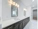 Bathroom featuring a dual sink vanity with undermount sinks, dark cabinetry and white countertop at 3206 Harrison Ave, Orlando, FL 32804