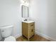 Modern powder room with stylish vanity, mirror, and hardwood floors at 3206 Harrison Ave, Orlando, FL 32804