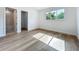 Inviting bedroom with wood floors, white walls, and natural light filtering through the window at 3206 Harrison Ave, Orlando, FL 32804