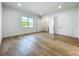 Spacious bedroom features hardwood floors, neutral walls, and ample natural light from a large window at 3206 Harrison Ave, Orlando, FL 32804