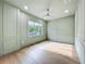 Light-filled bedroom with custom paneling, ceiling fan, and large window at 3206 Harrison Ave, Orlando, FL 32804