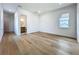 Bright bedroom featuring hardwood floors and a glimpse into an adjacent bathroom at 3206 Harrison Ave, Orlando, FL 32804