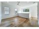 Bonus room with three windows, light floors, a ceiling fan, and white trim at 3206 Harrison Ave, Orlando, FL 32804