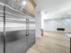 Modern stainless steel refrigerator integrated into cabinetry and open living area at 3206 Harrison Ave, Orlando, FL 32804