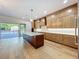 Large kitchen with custom cabinetry, oversized island and access to patio at 3206 Harrison Ave, Orlando, FL 32804
