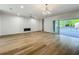 Open-concept living room with a fireplace, light floors, and glass doors to the pool at 3206 Harrison Ave, Orlando, FL 32804
