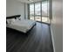 Bedroom with large windows offering cityscape views and modern flooring at 322 E Central Blvd # 1805, Orlando, FL 32801