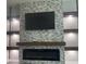 Contemporary fireplace and entertainment center featuring natural stone and wooden accents at 322 E Central Blvd # 1805, Orlando, FL 32801
