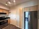 Modern kitchen featuring stainless steel appliances, light wood cabinets, and dark countertops at 322 E Central Blvd # 1805, Orlando, FL 32801