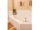 Corner jacuzzi-style tub with white tile surround, and chrome fixtures at 346 Canyon Stone Cir, Lake Mary, FL 32746