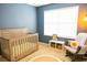 Bright Bedroom with a crib, rocking chair, and whimsical decor at 346 Canyon Stone Cir, Lake Mary, FL 32746