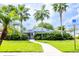 Community clubhouse featuring a fenced entrance, lush landscaping, and well-manicured lawn at 346 Canyon Stone Cir, Lake Mary, FL 32746