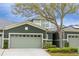 Inviting townhome featuring a gray exterior, a two-car garage, and manicured landscaping at 346 Canyon Stone Cir, Lake Mary, FL 32746