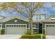 Inviting townhome featuring a gray exterior, a two-car garage, and manicured landscaping at 346 Canyon Stone Cir, Lake Mary, FL 32746