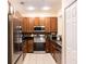 Modern kitchen with stainless steel appliances, granite countertops, and cherry wood cabinets at 346 Canyon Stone Cir, Lake Mary, FL 32746