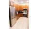 Modern kitchen with stainless steel appliances, granite countertops, and cherry wood cabinets at 346 Canyon Stone Cir, Lake Mary, FL 32746