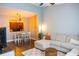 Open-concept living area with hardwood floors, a ceiling fan, a cream sectional, and natural light at 346 Canyon Stone Cir, Lake Mary, FL 32746
