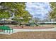 Community playground with slides, swings, and play structures surrounded by lush greenery and trees at 346 Canyon Stone Cir, Lake Mary, FL 32746