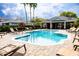 Inviting community swimming pool surrounded by lounge chairs and landscaping with a nearby clubhouse at 346 Canyon Stone Cir, Lake Mary, FL 32746