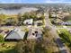 Beautiful aerial shot showcasing a residential area with a lake nearby, and green lawns at 3603 Westover Cir, Leesburg, FL 34748