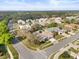 Aerial view of neighborhood with mature trees, well-maintained lawns and houses at 3603 Westover Cir, Leesburg, FL 34748
