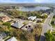 Overhead view of homes surrounded by lush greenery and a tranquil lake at 3603 Westover Cir, Leesburg, FL 34748