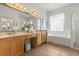 Bathroom featuring double sinks, a vanity area, and a separate shower and tub at 3603 Westover Cir, Leesburg, FL 34748