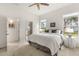 Bright bedroom with a ceiling fan, a large window, and an ensuite bathroom at 3603 Westover Cir, Leesburg, FL 34748