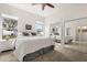 Bright bedroom features a ceiling fan, mirrored closet doors, and a large window with a view at 3603 Westover Cir, Leesburg, FL 34748