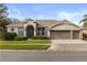 Inviting single-story home with a well-manicured lawn, complemented by a 3 car garage and neutral color palette at 3603 Westover Cir, Leesburg, FL 34748