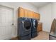 Laundry room with a full-size washer and dryer, and extra cabinet space at 3603 Westover Cir, Leesburg, FL 34748